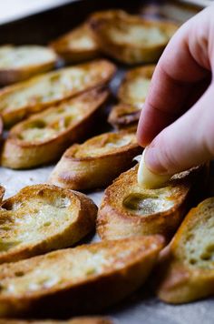 a person is dipping something into some bread