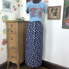 "Vintage Blue Floral Maxi Skirt, Navy Blue with White Frog & Flower Print in Size XS.  Pretty 1970s Maxi Skirt is so much fun for all seasons.   This is a very long skirt with an A-line silhouette.  This has white button closures up the front of the skirt, but it is open from about the middle of the thigh, and down.  There are two pockets on this, and it has a tailored waistband.   This looks like a basic floral print at first glance; but if you look more closely, you will see adorable little fr Chic Blue Maxi Skirt With Floral Print, Pattern Skirt Outfit, Vintage Floral Print Maxi Skirt, Blue Floral Print Relaxed Skirt, 70s Floral Skirt, Retro Blue Floral Print Skirt, 1970s Hippie, Blue Maxi Skirt, Printed Long Skirt