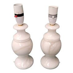 two white vases sitting on top of each other