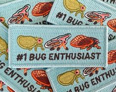 several patches with bugs on them are in the shape of a heart and have words that read 1 bug enthusiast