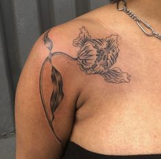 a woman with a flower tattoo on her shoulder