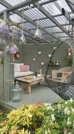 an outdoor living area with wicker furniture and plants