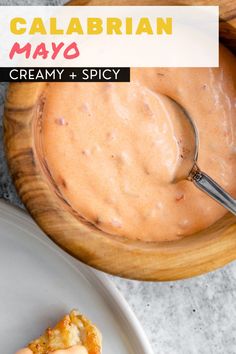 a close up of food on a plate with a spoon and sauce in the bowl