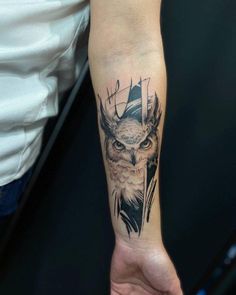 an owl tattoo on the left arm and wrist is shown in black ink, while it has