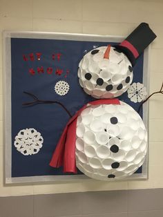 a snowman made out of toilet paper is hanging on the wall