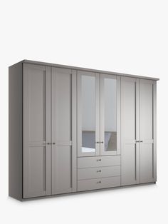 a large white wardrobe with mirrored doors and drawers