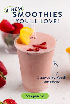 a smoothie with strawberries and lemon on the side, next to other fruit