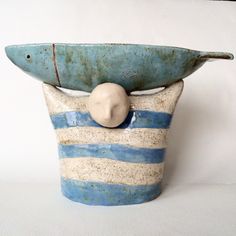 a blue and white vase with a stone in it