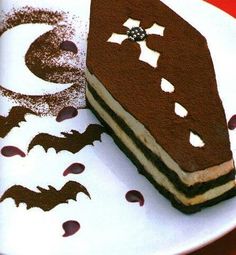 a piece of cake sitting on top of a white plate with bats drawn on it