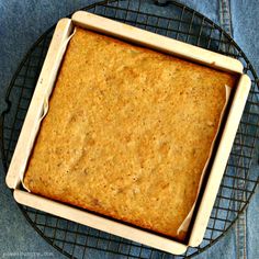 a square cake sitting on top of a cooling rack