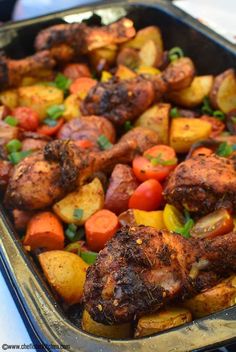 a pan filled with meat and vegetables on top of a table