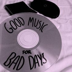 a cd with the words good music for bad days written on it and a pair of scissors