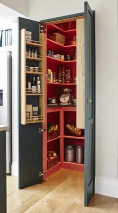 an open pantry door in the middle of a kitchen