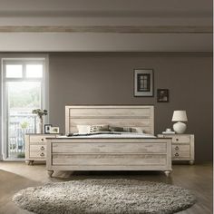 a bedroom scene with focus on the bed and dressers in the foreground, light wood flooring and large windows