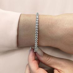 a woman's arm with a diamond bracelet on it