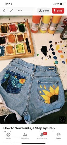 an image of someone's jean shorts with sunflowers painted on them