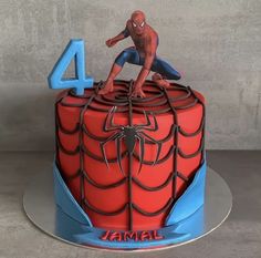 a spiderman cake with the number four on top and an image of him jumping over it