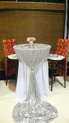 the table is covered with silver cloth