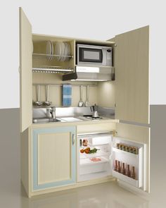 an open refrigerator with its door wide open in a kitchen area that has white walls and beige cabinets