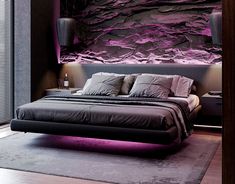 a large bed sitting in a bedroom next to a purple rock wall on the wall