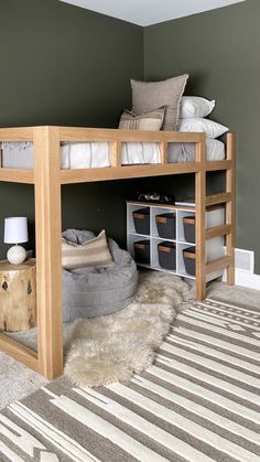 a loft bed with a desk underneath it in a room that has carpeted flooring