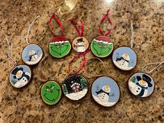 christmas ornaments with snowmen and santa hats on them