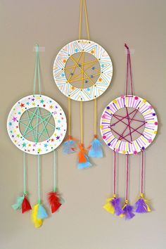 three paper plates with tassels hanging from the sides and one has a star design on it