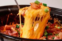 a close up of food in a pan with a spatula sticking out of it