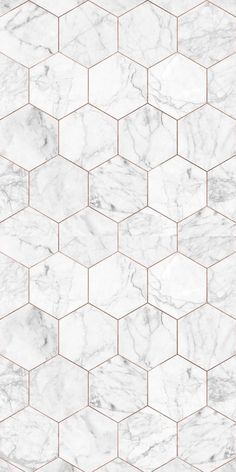 a white marble tile wallpaper with hexagonal tiles in the middle and gold lines