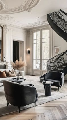 a living room filled with furniture and a spiral staircase