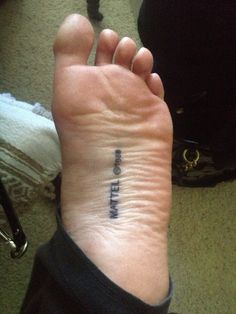 a person with a small tattoo on their left foot that says, i love you