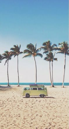 a vw van parked on the beach with palm trees behind it and a sign that says supreme