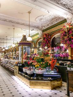 the interior of a flower shop with flowers in vases