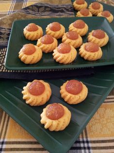 small pizzas on green plates sitting on a table