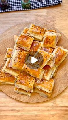 a wooden cutting board topped with waffles on top of a table