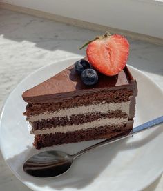 a piece of chocolate cake on a plate with a fork