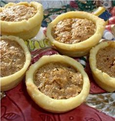 four small pies sitting on top of a red plate