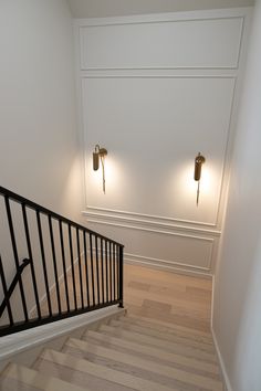 an empty staircase with two lights on each side