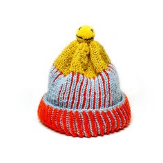 a knitted hat with a yellow and red stripe on the front, sitting against a white background