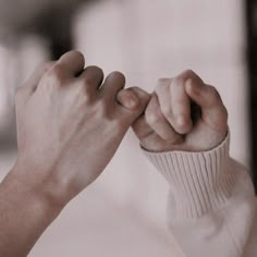 two hands holding each other in the air