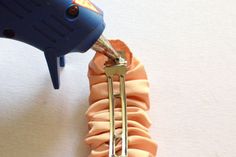 a pair of scissors is being used to trim a piece of fabric that has been curled into a spiral