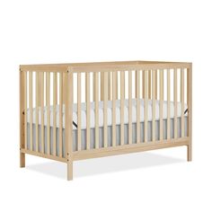 a wooden crib with white sheets on the bottom and side rails, against a white background