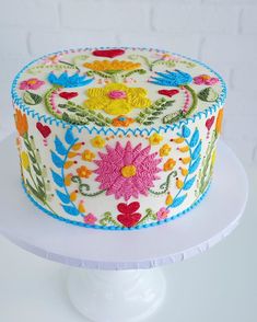 a decorated cake sitting on top of a white plate