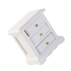 a white cabinet with three drawers and two gold knobs on the front door handle