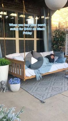 a person laying on a bed in front of a building with a sign that says when you buy your porch furniture, there $ 600 and friday