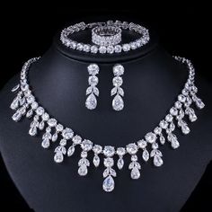 Elevate your prom look with this fashion bridal necklace set. The set includes a stunning necklace and matching accessories, adding a touch of elegance and sophistication to your ensemble. – This bridal a plus cubic zirconia gemstone necklace set is perfect for adding elegance to any bridal ensemble.– Made with high-quality materials, this set includes a stunning necklace and matching earrings for a complete look.– Perfect for pageant, bridal, bridesmaid, prom, quinceañera or special occasion. Prom Jewelry Sets, Crystal Bridal Jewelry Sets, Zircon Necklace, Silver Necklace Set, Bridal Necklace Set, Bridal Jewelry Set, Prom Jewelry, Dangle Necklaces, Women's Jewelry Sets