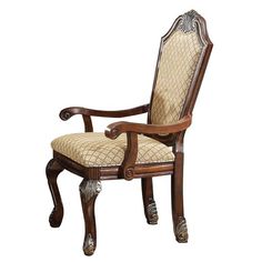 an ornate wooden arm chair with fabric upholstered back and arms, on white background