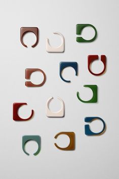 several different colored pieces of metal on a white surface, with the letter c in the middle