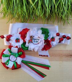 two red and white flowers are sitting next to each other on a table with green grass