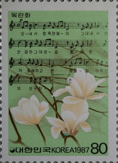 a stamp with flowers on it and music notes in the backgrounnds